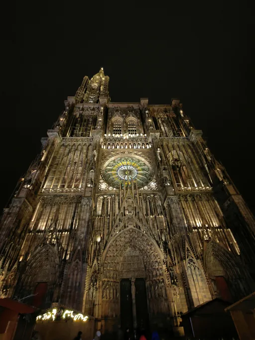 Strasbourg Cathedral lit at night, seen from the square